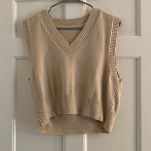 Cream sweater vest.